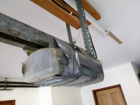 A very old Challenger garage door opener temporary DIY fix with duct tape.